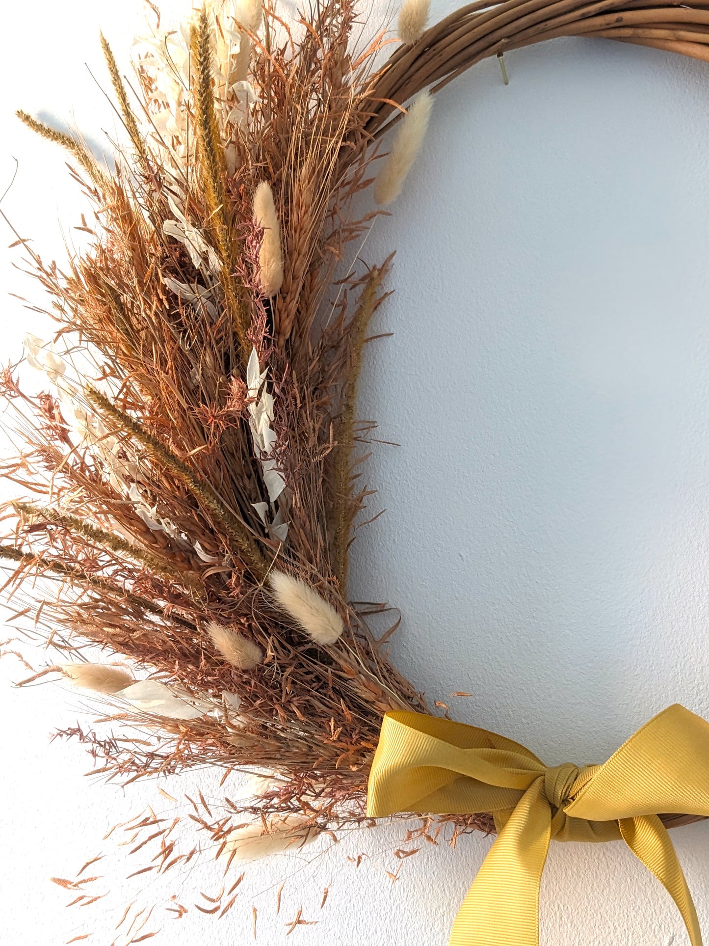 dried flower wreath with yellow ribbon